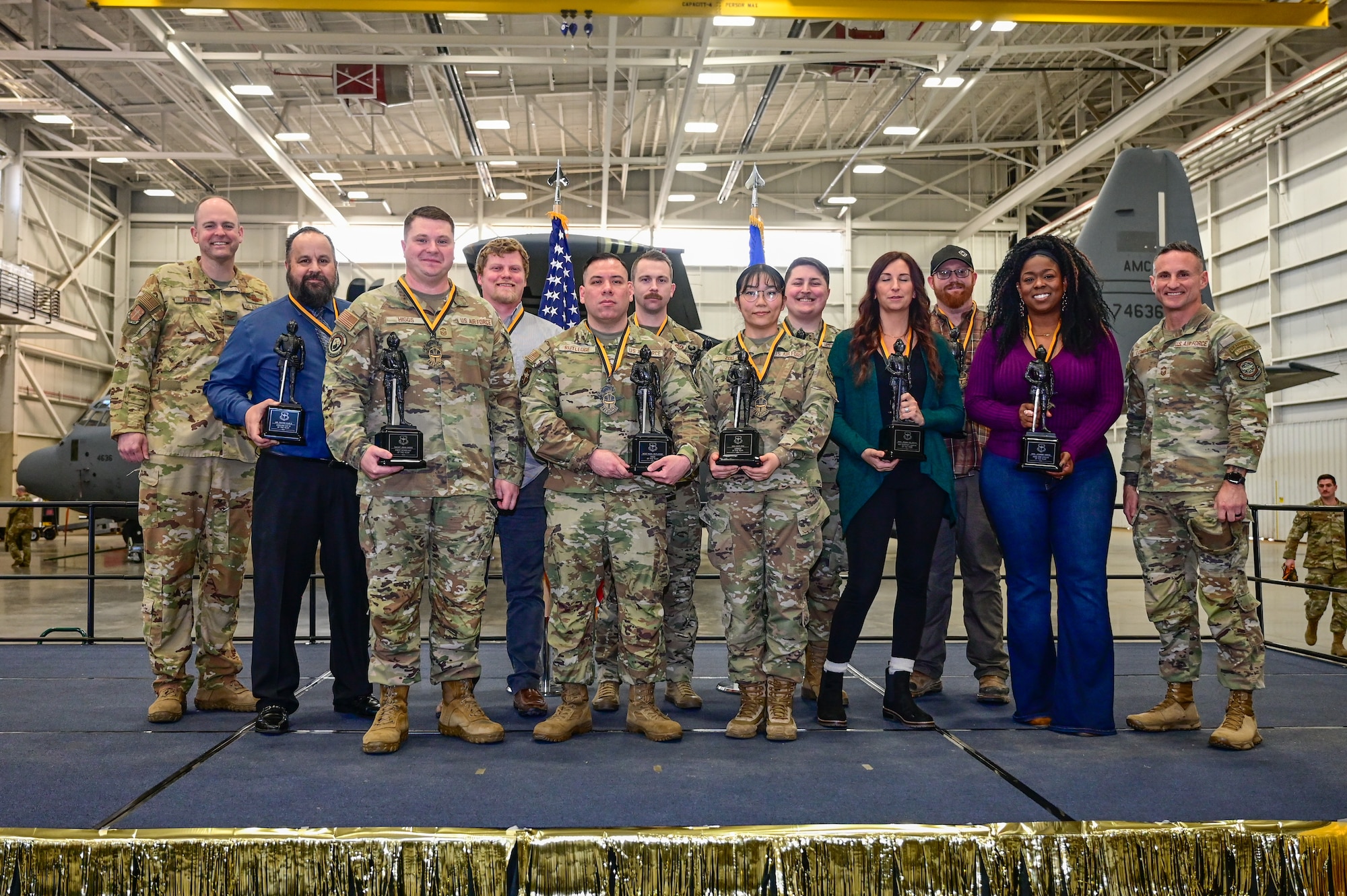 Leadership from the 19th Airlift Wing stand with award winners during the 19 AW Annual Awards Ceremony at Little Rock Air Force Base, Arkansas, Feb. 13, 2025. Congratulations to the Annual Award winners. Your exceptional dedication and effort showcase what it truly means to be a Black Knight.