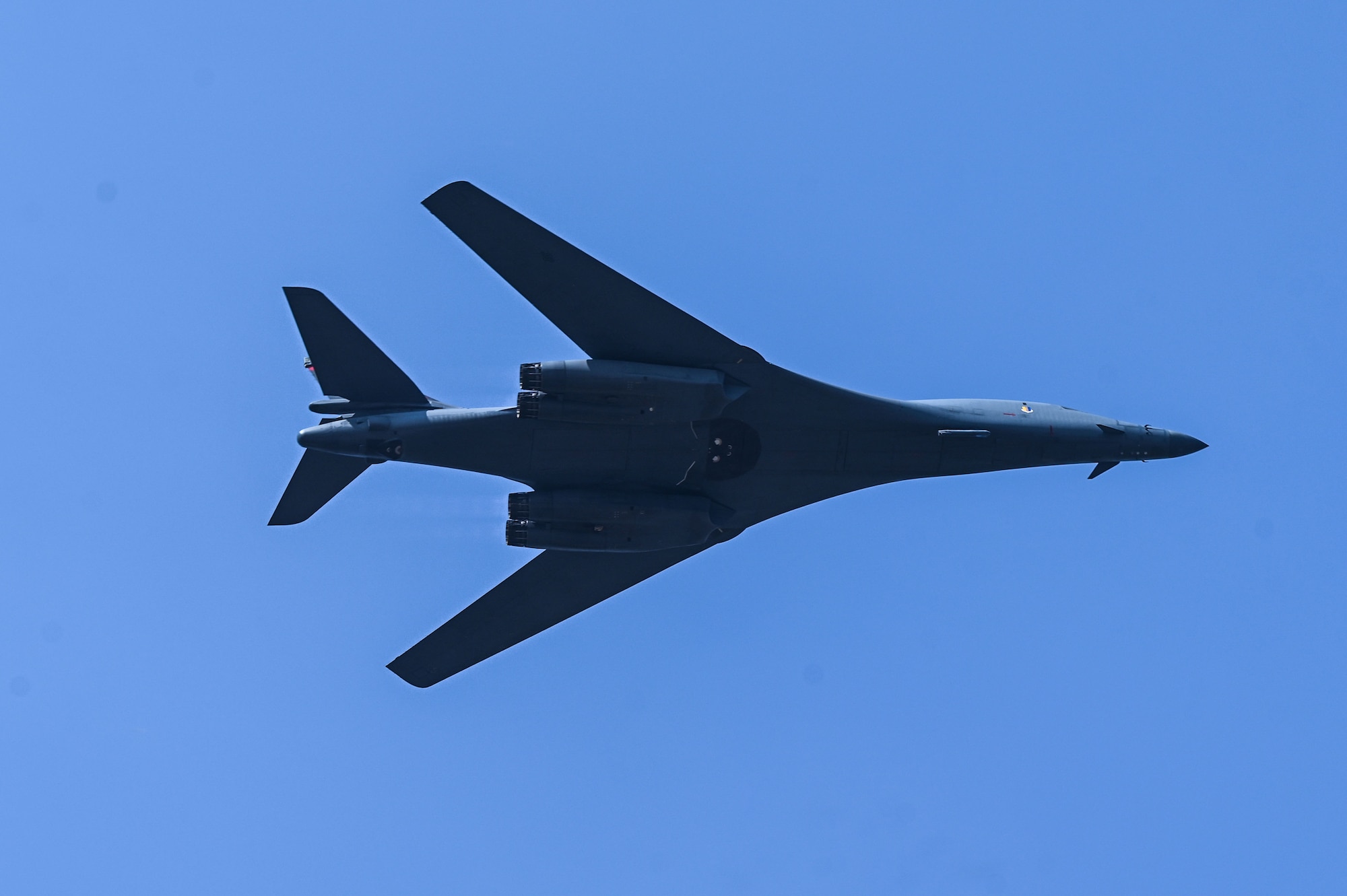 A U.S. Air Force B-1B Lancer assigned to the 34th Expeditionary Bomb Squadron, Ellsworth Air Force Base, S.D., tilts sideways while conducting a fly over at Aero India air show at Yelahanka Air Force Station, Bengaluru, India, Feb. 13, 2025.