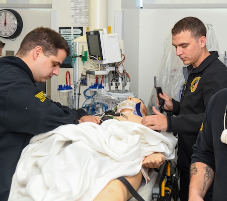 Lt. Junior Grade Andrew Mappus, critical care nurse, right, and Jesiah Hostetler, critical care paramedic, transport a simulated casualty into the emergency room during a trauma drill at Naval Medical Center Camp Lejeune on October 18, 2024. The drill reviews processes and procedures in place for trauma care.