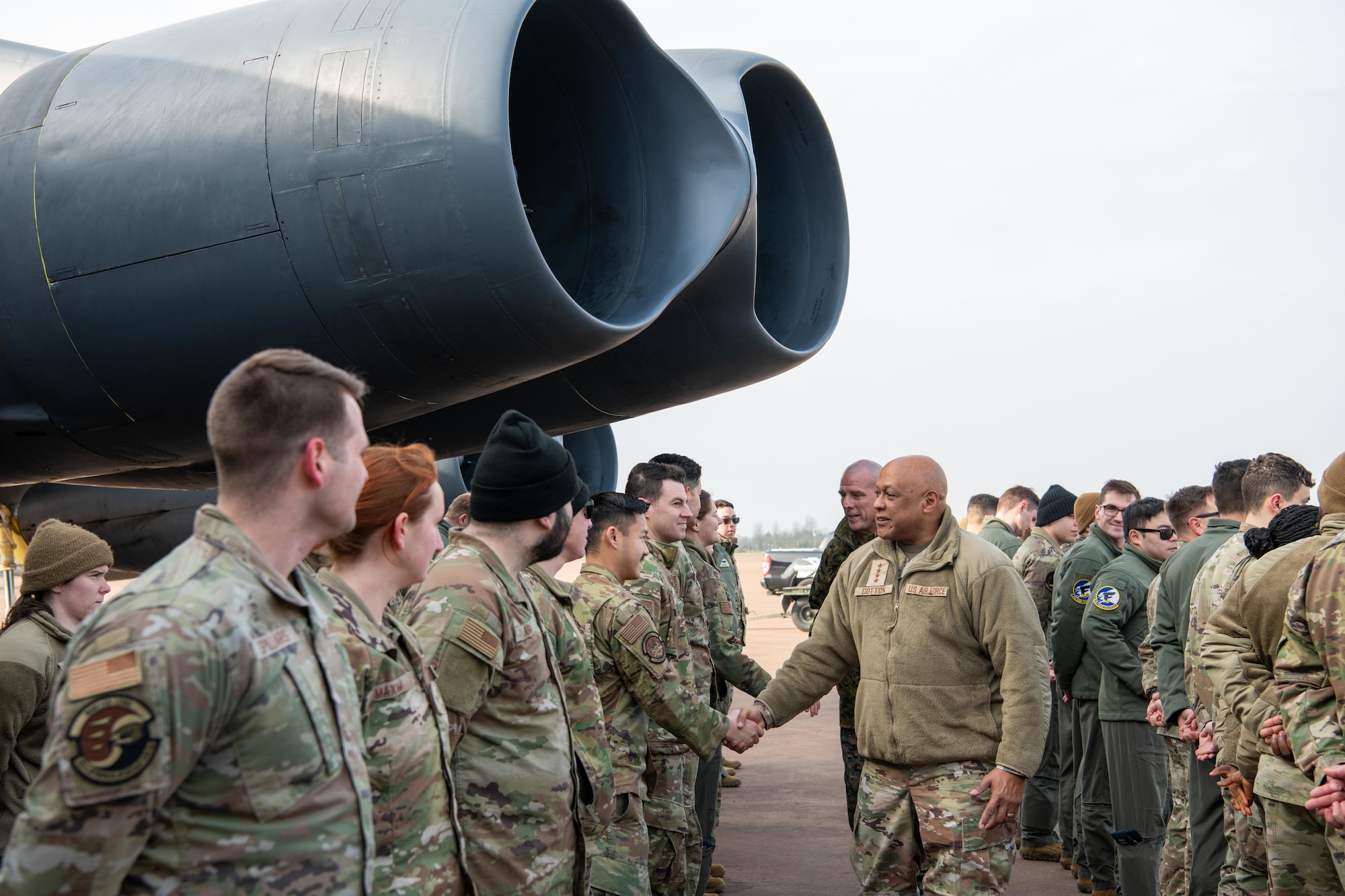 A leader shakes hands with deployed members