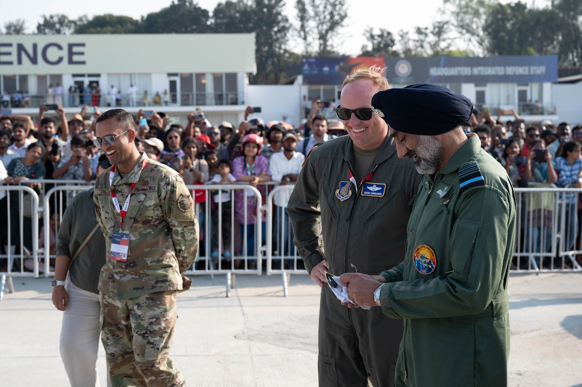 Indian Air Force Air Chief Marshal Amar Preet Singh, Chief of the Air Staff, speaks with U.S. Air Force Lt. Col. Michael Chmielewski, Air Boss for the  Aero India team during the Aero India 2025 air show, at Yelahanka Air Force Station, Bengaluru, India, Feb. 13, 2025.