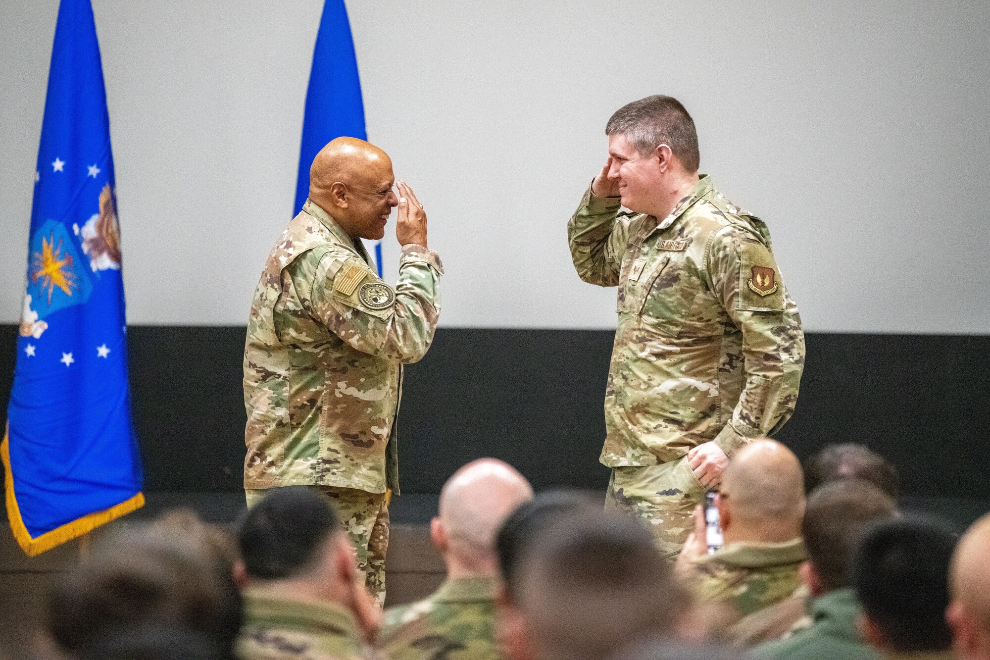 A leader returns a salute during an all call