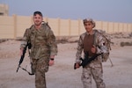 Left to right, West Virginia Air National Guard Senior Airman Max Howard and National Service Academy Recruit Nooh Mashhadi participate in a ruck march during the Best Warrior Competition at the National Service Academy in Umm Salal Muhammed, Qatar, Feb. 3, 2025. The West Virginia National Guard and Qatar Armed Forces are partners in the State Partnership Program.