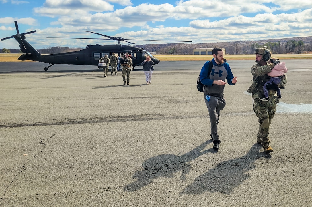 Airmen from the Kentucky Air National Guard’s 123rd Contingency Response Group receive flood victims arriving at the Big Sandy Regional Airport in Debord, Kentucky, Feb. 17, 2025.