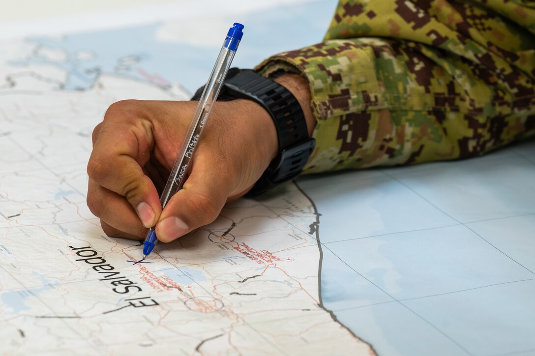 A member from the El Salvador army marks a map during the Jaguar Sentinel tabletop exercise scenario portion in San Salvador, El Salvador, February 12, 2025.