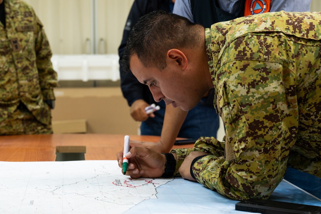 A member from the El Salvador army marks a map during the Jaguar Sentinel tabletop exercise scenario portion in San Salvador, El Salvador, February 12, 2025.