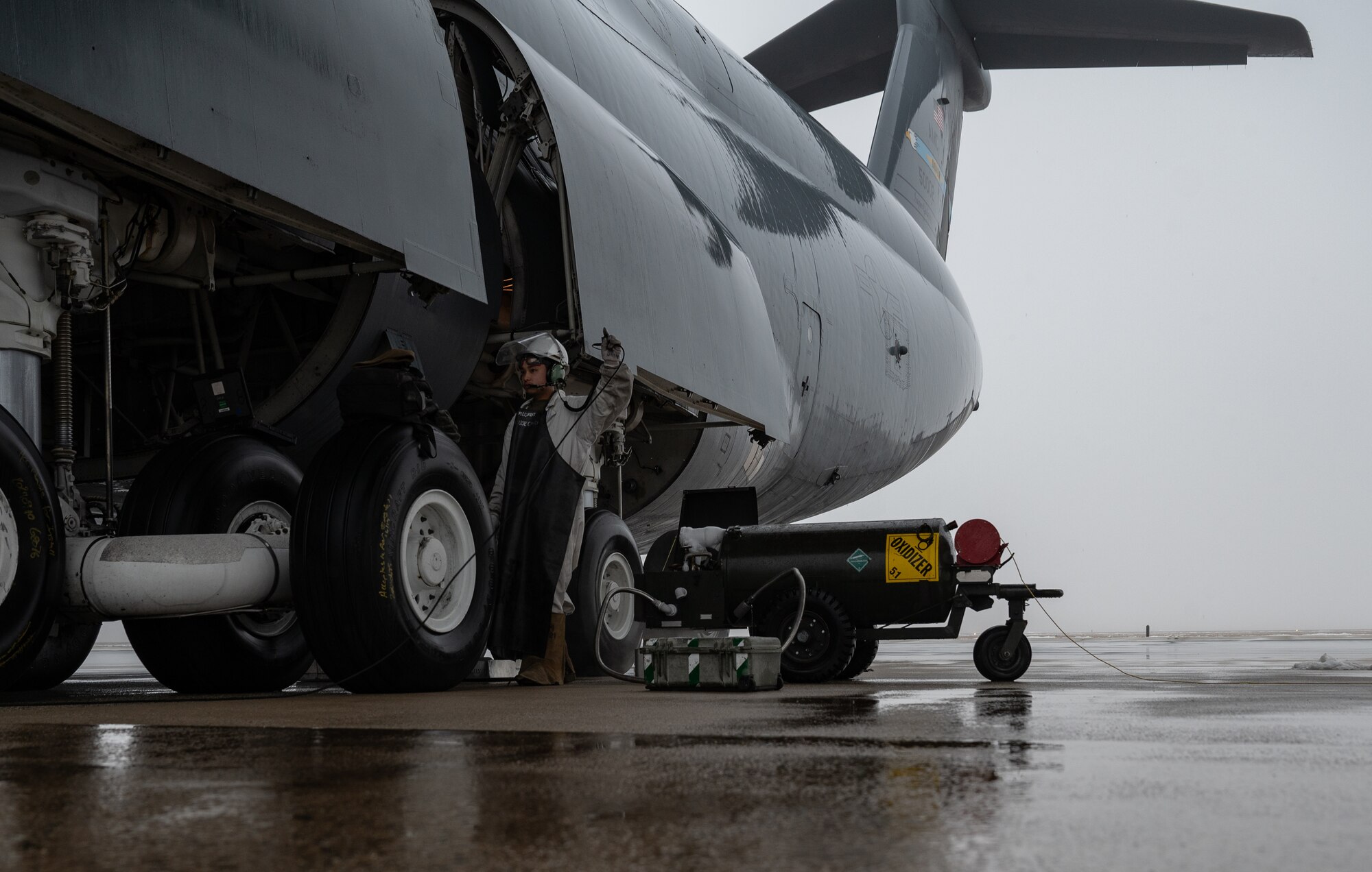 U.S. Airman 1st Class Brandon Rabago, 436th Aircraft Maintenance Squadron C-5M Super Galaxy apprentice, sets up a liquid oxygen connection to a C-5 at Dover Air Force Base, Delaware, Feb. 13, 2025. The C-5 was set for a vapor purge test conducted by the 46th Test and Evaluation Squadron. (U.S. Air Force photo by Airman 1st Class Liberty Matthews)