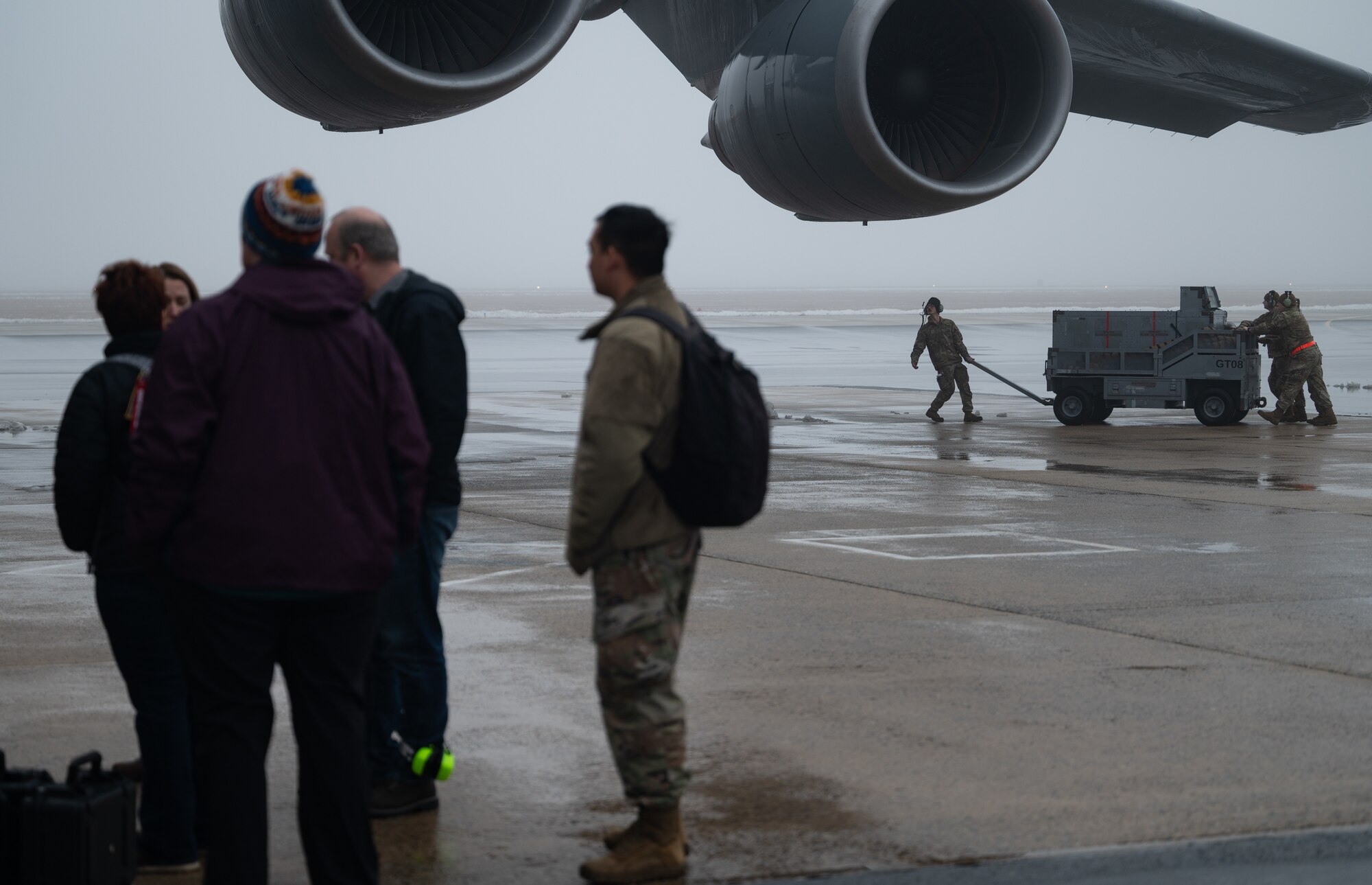 Team Dover Airmen move a ground power unit for a vapor purge test for C-5M Super Galaxy at Dover Air Force Base, Delaware, Feb. 13, 2025. Sensors placed inside the C-5 by the 46th Test and Evaluation Squadron measured how long it took for the vapor to be purged during flight. (U.S. Air Force photo by Airman 1st Class Liberty Matthews)
