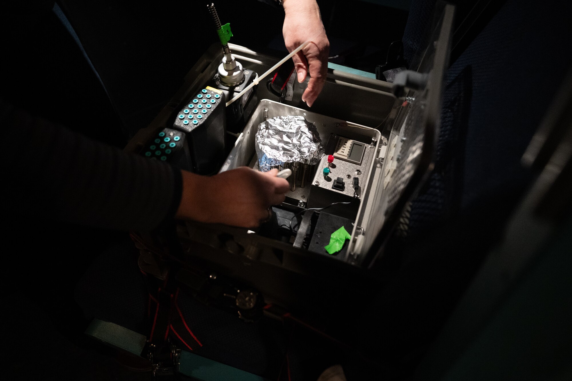 A 46th Test and Evaluation Squadron member adjusts a high-fidelity testing unit in a C-5M Super Galaxy at Dover Air Force Base, Delaware, Feb. 13, 2025. Sensors placed inside the C-5 by the 46th TES measured how long it took for the vapor to be purged during flight. (U.S. Air Force photo by Airman 1st Class Liberty Matthews)