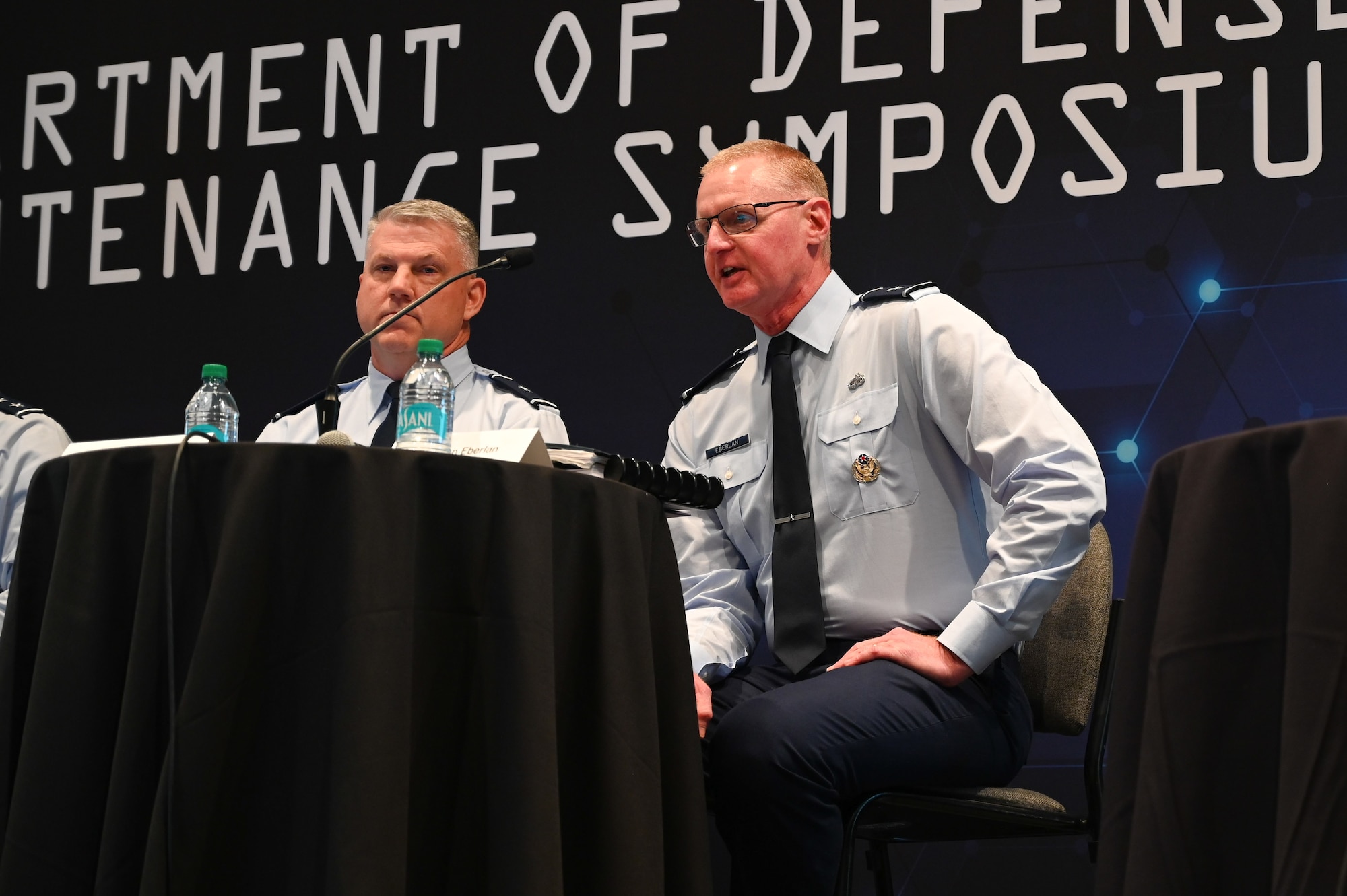 Military men hosting a town hall meeting
