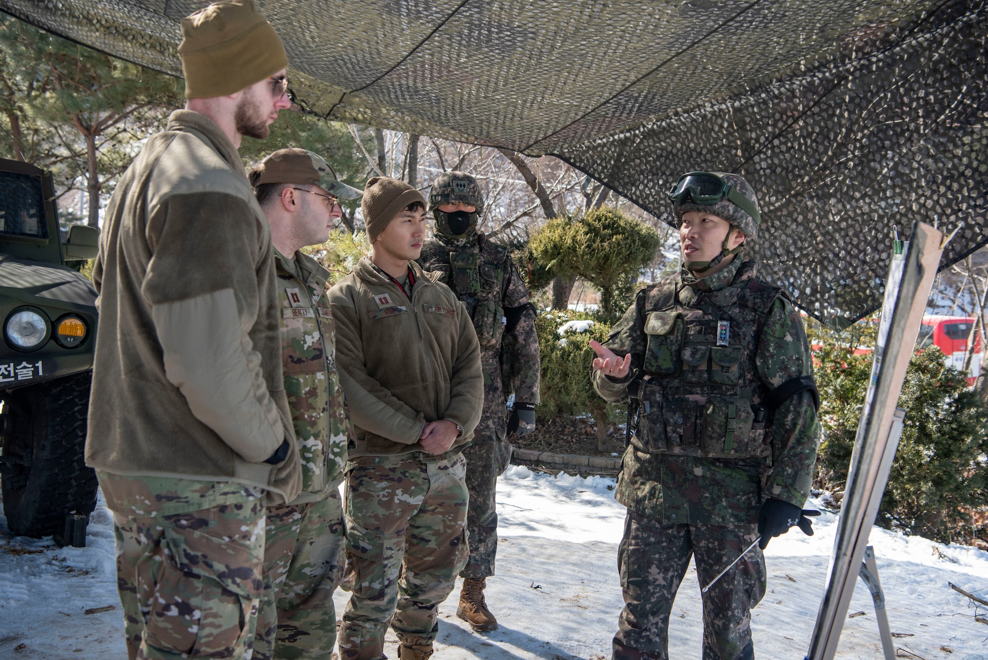 Republic of Korea Army Lt. Col. Daesoo Kang, 112th Mechanized Infantry Battalion commander, right, briefs 51st Fighter Wing members about the details of a joint exercise in Hongcheon