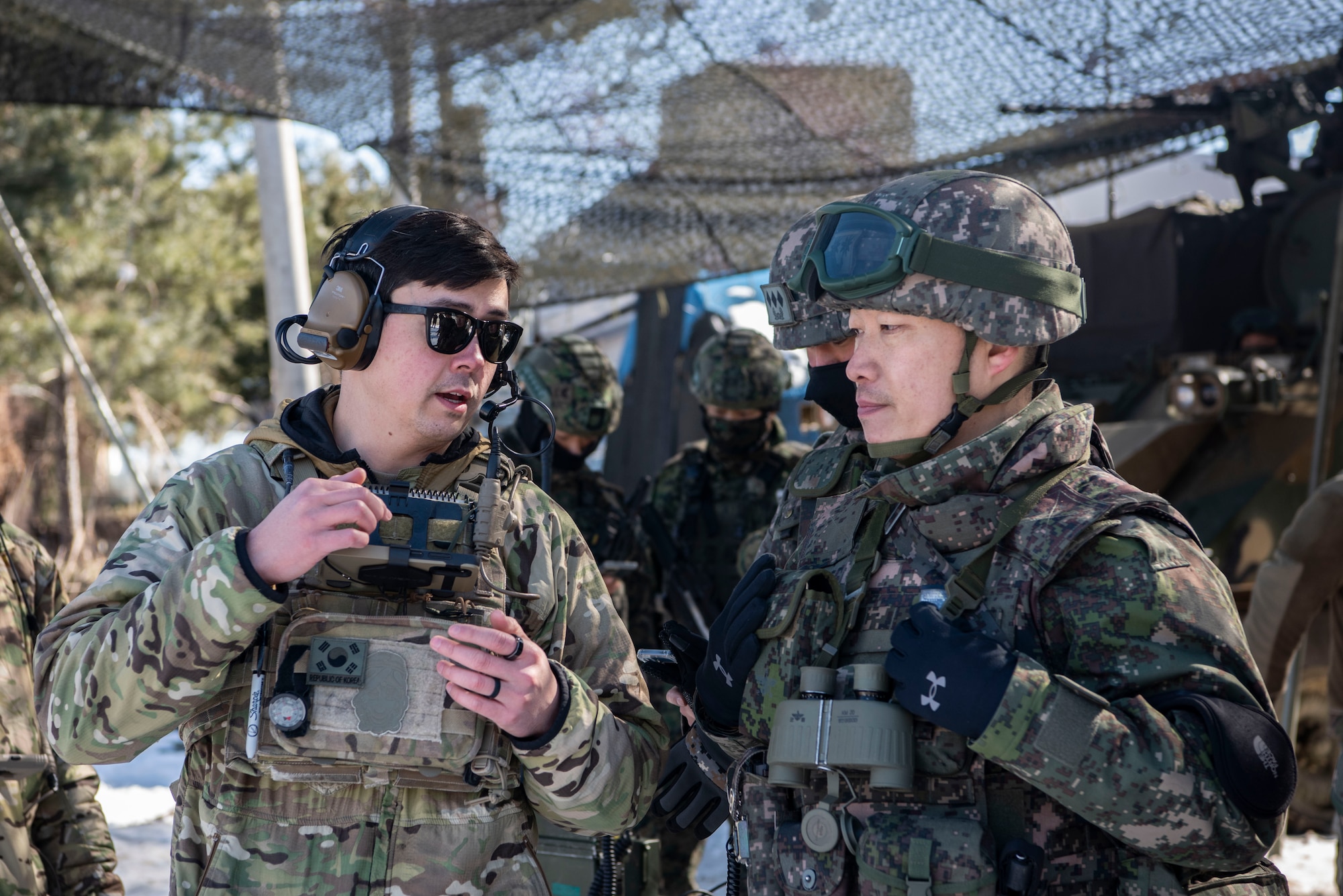 U.S. Air Force Staff Sgt. Kai Wakeland, 607th Air Support Operations Group joint terminal attack controller, left, briefs Republic of Korea Army Lt. Col. Daesoo Kang, 112th Mechanized Infantry Battalion commander, about air asset positioning during a joint exercise in Hongcheon