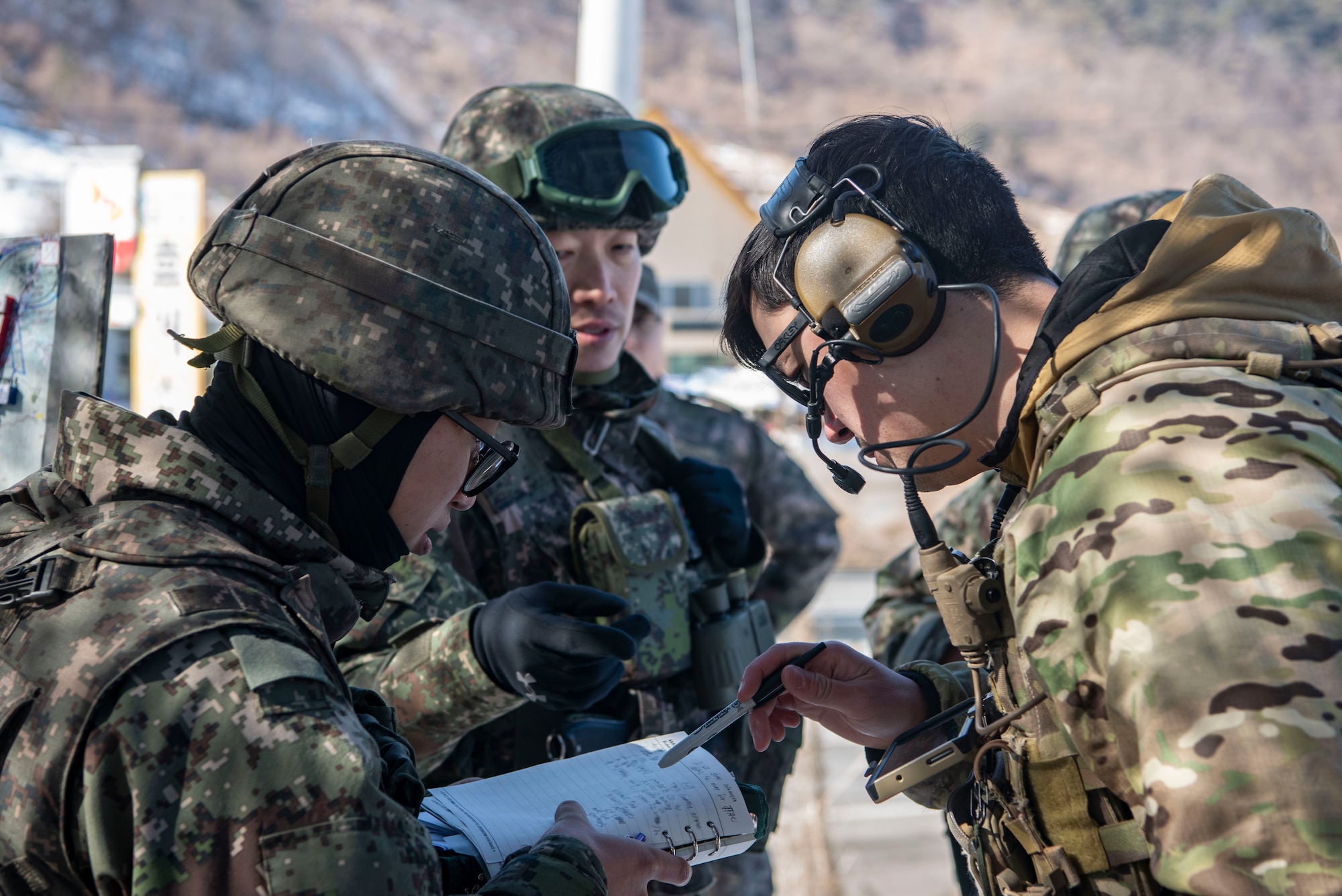 U.S. Air Force Staff Sgt. Kai Wakeland, 607th Air Support Operations Group joint terminal attack controller, right, receives targeting information from Republic of Korea sources during a joint exercise in Hongcheon