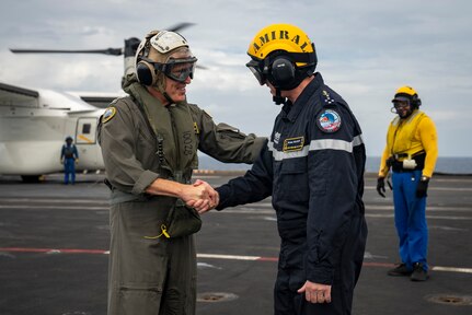 Adm. Steve Koehler, commander, U.S. Pacific Fleet, and Adm. Nicolas Vaujour, chief of staff of the French Navy, greet one another aboard the aircraft carrier FS Charles De Gaulle (R 91) in the Philippine Sea during Pacific Steller 2025, Feb. 14.