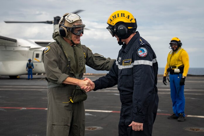 Adm. Steve Koehler, commander, U.S. Pacific Fleet, and Adm. Nicolas Vaujour, chief of staff of the French Navy, greet one another aboard the aircraft carrier FS Charles De Gaulle (R 91) in the Philippine Sea during Pacific Steller 2025, Feb. 14.