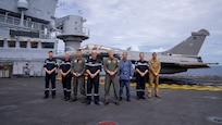 From left, Capt. Georges-Antoine Florentin, commanding officer of the aircraft carrier FS Charles De Gaulle (R 91); Adm. Guillaume Pinget, commander, Armed Forces of French Polynesia; U.S. Navy Rear Adm. Michael Wosje, commander, Carrier Strike Group (CSG) ONE; Adm. Nicolas Vaujour, chief of staff of the French Navy; Adm. Steve Koehler, commander, U.S. Pacific Fleet; Rear Adm. Natsui Takashi, commander, Japan-Maritime Self-Defense Force Escort Flotilla Four; Rear Adm. Jacques Mallard, commander, French Carrier Strike Group; and Cmdr. Guillaume Denis, commander, French Carrier Air Wing, join together on the flight deck of Charles De Gaulle in the Philippine Sea during Pacific Steller 2025, Feb. 14.