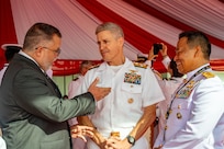 BALI, Indonesia (Feb. 16, 2025) - Adm. Steve Koehler, commander, U.S. Pacific Fleet, center, greets Mario Ignacio Artaza, Republic of Chile ambassador to the Association of Southeast Asian Nations, left, alongside Indonesian Navy Rear Adm. Achmad Wibisono during the opening ceremony of Multilateral Naval Exercise Komodo (MNEK) 2025 in Bali, Indonesia, Feb. 16. Hosted by the Indonesian Navy, MNEK 2025 is an international, joint exercise taking place in the vicinity of Bali, Indonesia, emphasizing multilateral maritime cooperation and disaster response. (U.S. Navy photo by Mass Communication Specialist 1st Class Caroline H. Lui)
