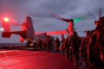 U.S. Marines with Battalion Landing Team 2/4, 31st Marine Expeditionary Unit, embark an U.S. Marine Corps MV-22 Osprey with Marine Medium Tiltrotor Squadron 262 (Rein.) aboard the amphibious assault ship USS America (LHA 6), during a tactical recovery of aircraft and personnel exercise in the Philippine Sea, Feb. 13, 2025.