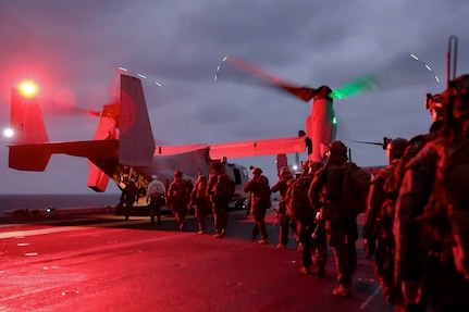 U.S. Marines with Battalion Landing Team 2/4, 31st Marine Expeditionary Unit, embark an U.S. Marine Corps MV-22 Osprey with Marine Medium Tiltrotor Squadron 262 (Rein.) aboard the amphibious assault ship USS America (LHA 6), during a tactical recovery of aircraft and personnel exercise in the Philippine Sea, Feb. 13, 2025.