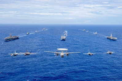 PHILIPPINE SEA (Feb. 12, 2025) — Aircraft from the Carl Vinson Carrier Strike Group (VINCSG) and French Carrier Strike Group (CSG) fly in formation over the Philippine Sea with ships from VINCSG, French CSG, the Japan Maritime Self-Defense Force (JMSDF), and U.S. Military Sealift Command (MSC) during Pacific Steller 2025, Feb. 12. From left, an F/A-18F Super Hornet, F-35C Lightning II, E-2D Advanced Hawkeye, and two French Navy Rafale Marine (F4) fighter jets. The ships from VINCSG include the Nimitz-class aircraft carrier USS Carl Vinson (CVN 70), Ticonderoga-class guided-missile cruiser USS Princeton (CG 59), and Arleigh Burke-class guided-missile destroyers USS Sterett (DDG 104) and USS William P. Lawrence (DDG 110). The ships from French CSG include the aircraft carrier FS Charles De Gaulle (R 91) and its escort of air-defense destroyers and multi-mission frigates. The ships from JMSDF include the Izumo-class multi-functional destroyer JS Kaga (DDH 184) and Akizuki-class destroyer JS Akizuki (DD 115). The ships from MSC include the Henry J. Kaiser-class fleet replenishment oiler USNS Tippecanoe (T-AO 199) and Lewis and Clark-class dry cargo and ammunition ship USNS Charles Drew (T-AKE 10). VINCSG is underway conducting Pacific Steller 2025, a multi-large deck event with French CSG and JMSDF, fostering our alliance and maritime security in support of a free and open Indo-Pacific.  (U.S. Navy photo by Mass Communication Specialist Seaman Apprentice Pablo Chavez)