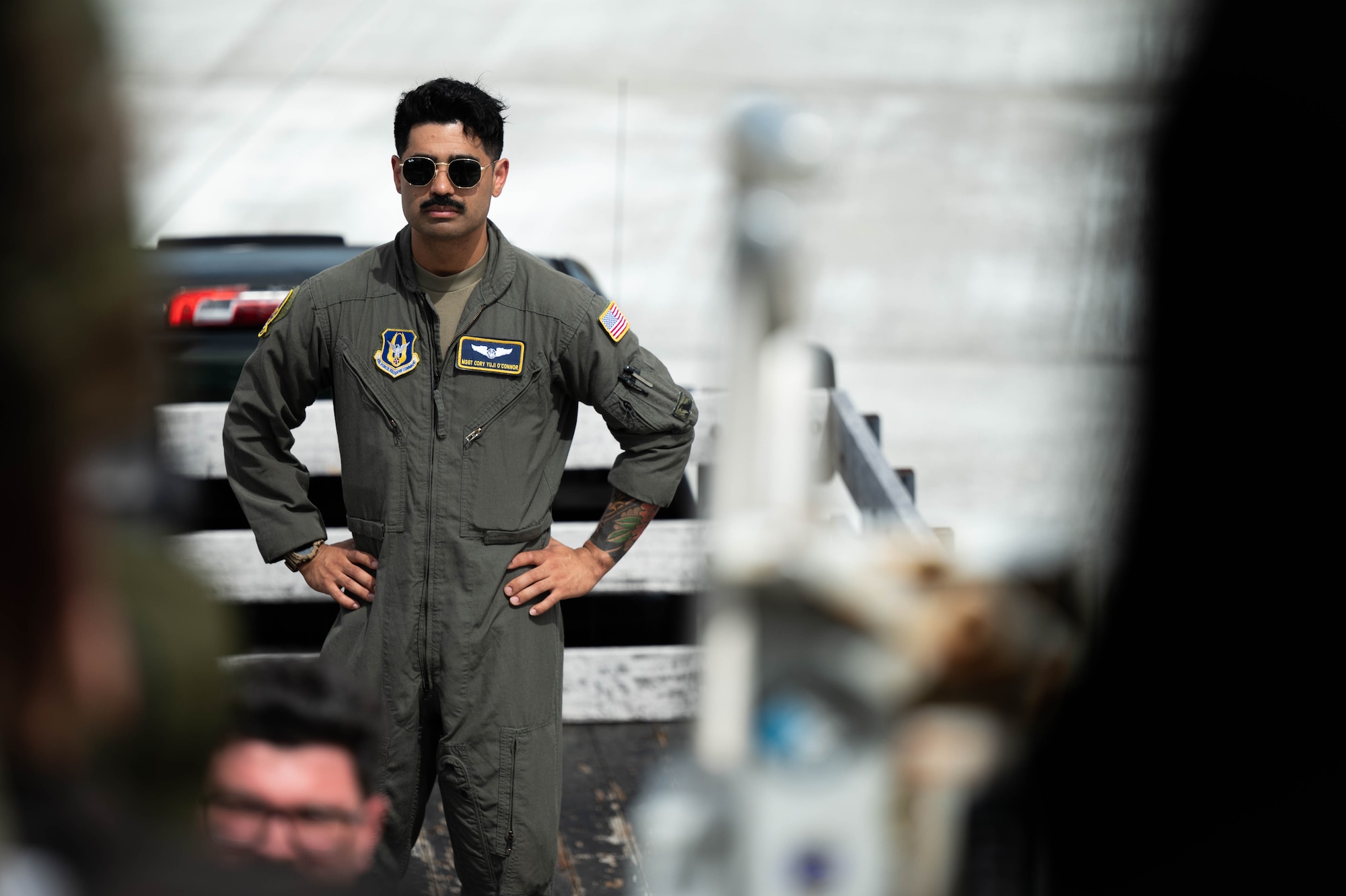 Air force boom operator ready to assist during baggage unload