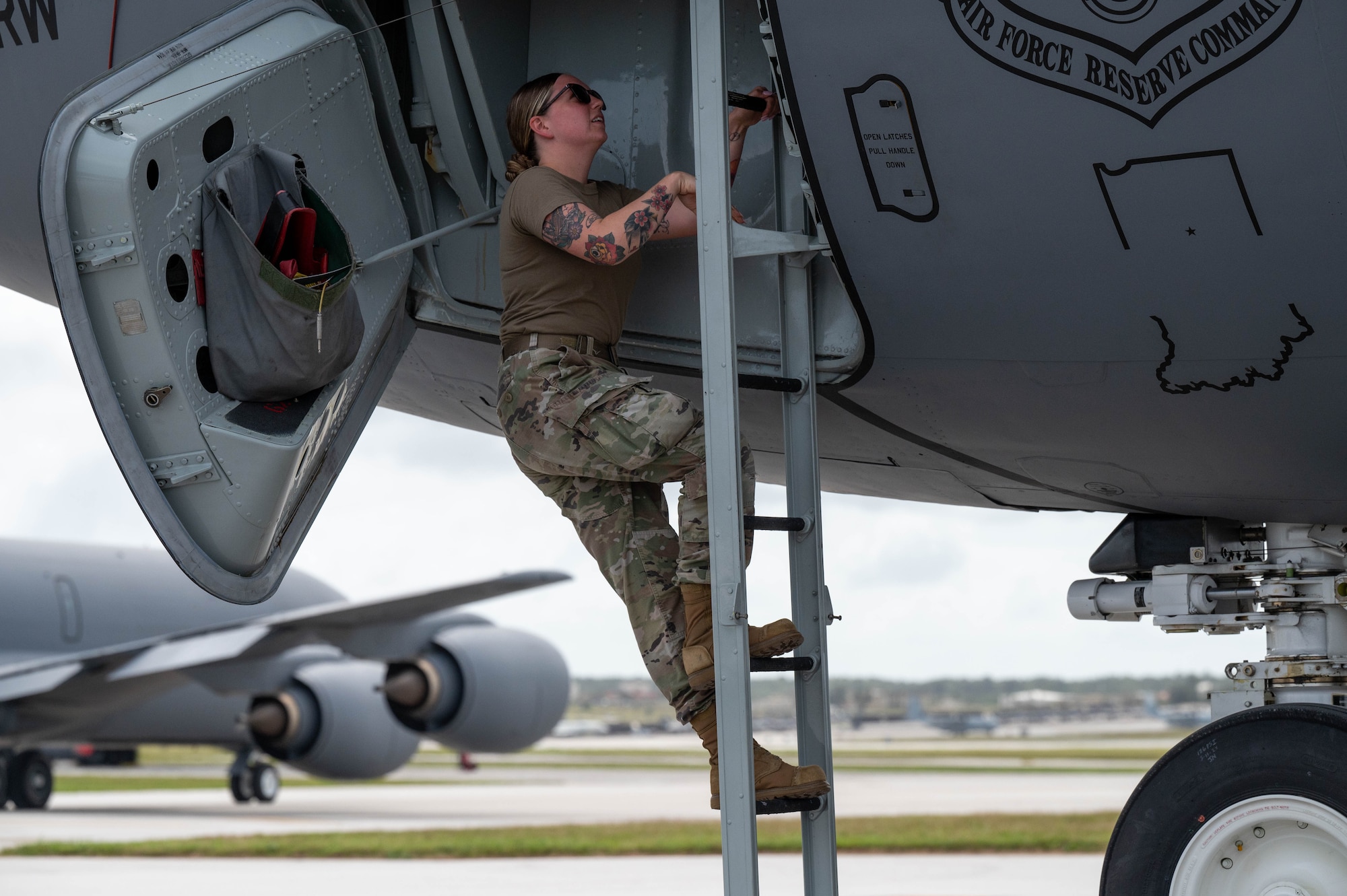 Airman climbs ladder up to flight deck of KC-135