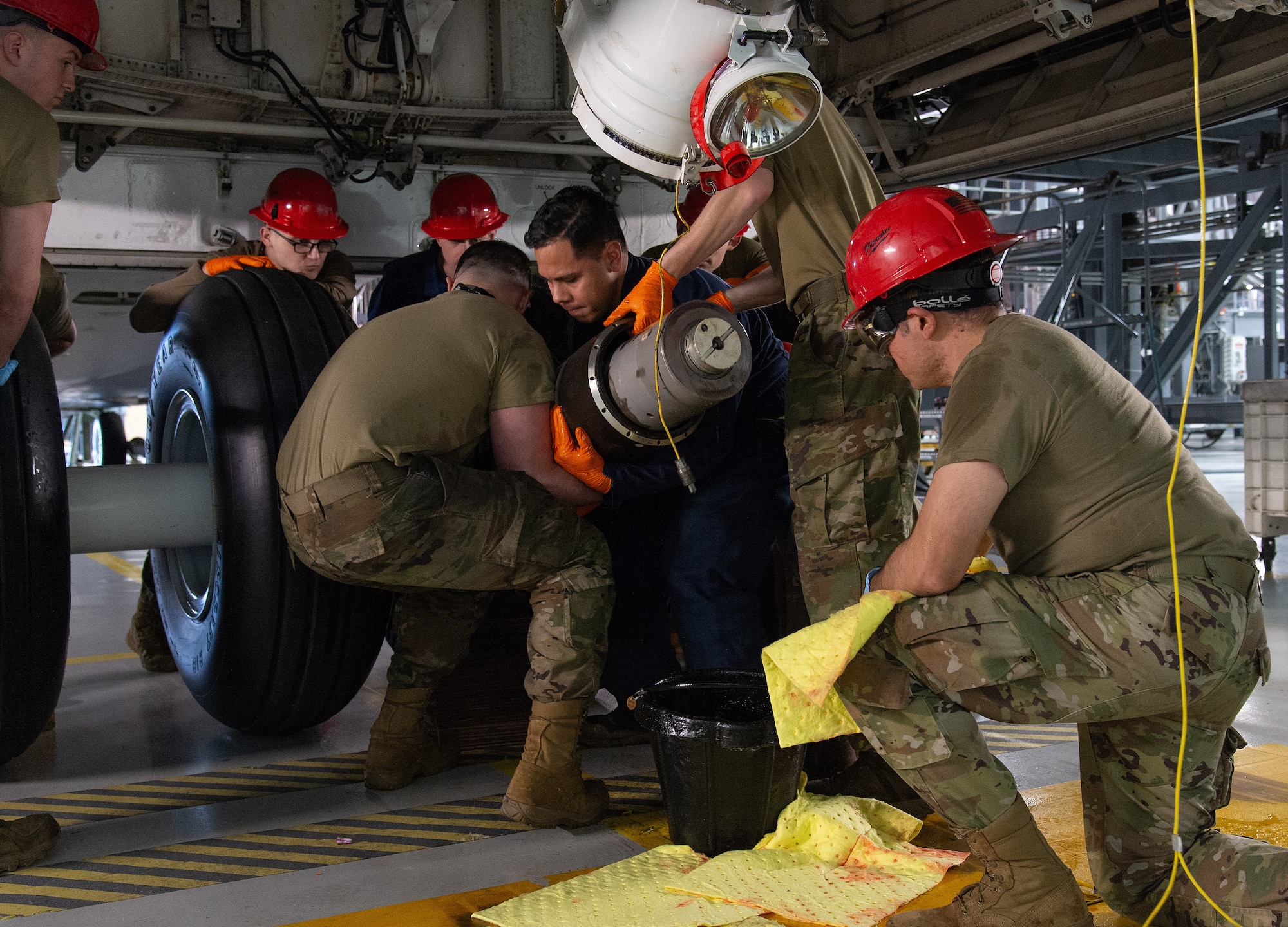U.S. Air Force aircraft hydraulic systems specialists from the 436th Maintenance Squadron, lower the C-5M Super Galaxy nose landing gear strut assembly to accomplish the removal and replacement of the internal seals at Dover Air Force Base, Delaware, Feb. 7, 2025. The Hydraulics Section is one of five flights within the 436th MXS that inspects, maintains, services and repairs C-5M and C-17 Globemaster III hydraulic systems and associated components. (U.S. Air Force photo by Roland Balik)