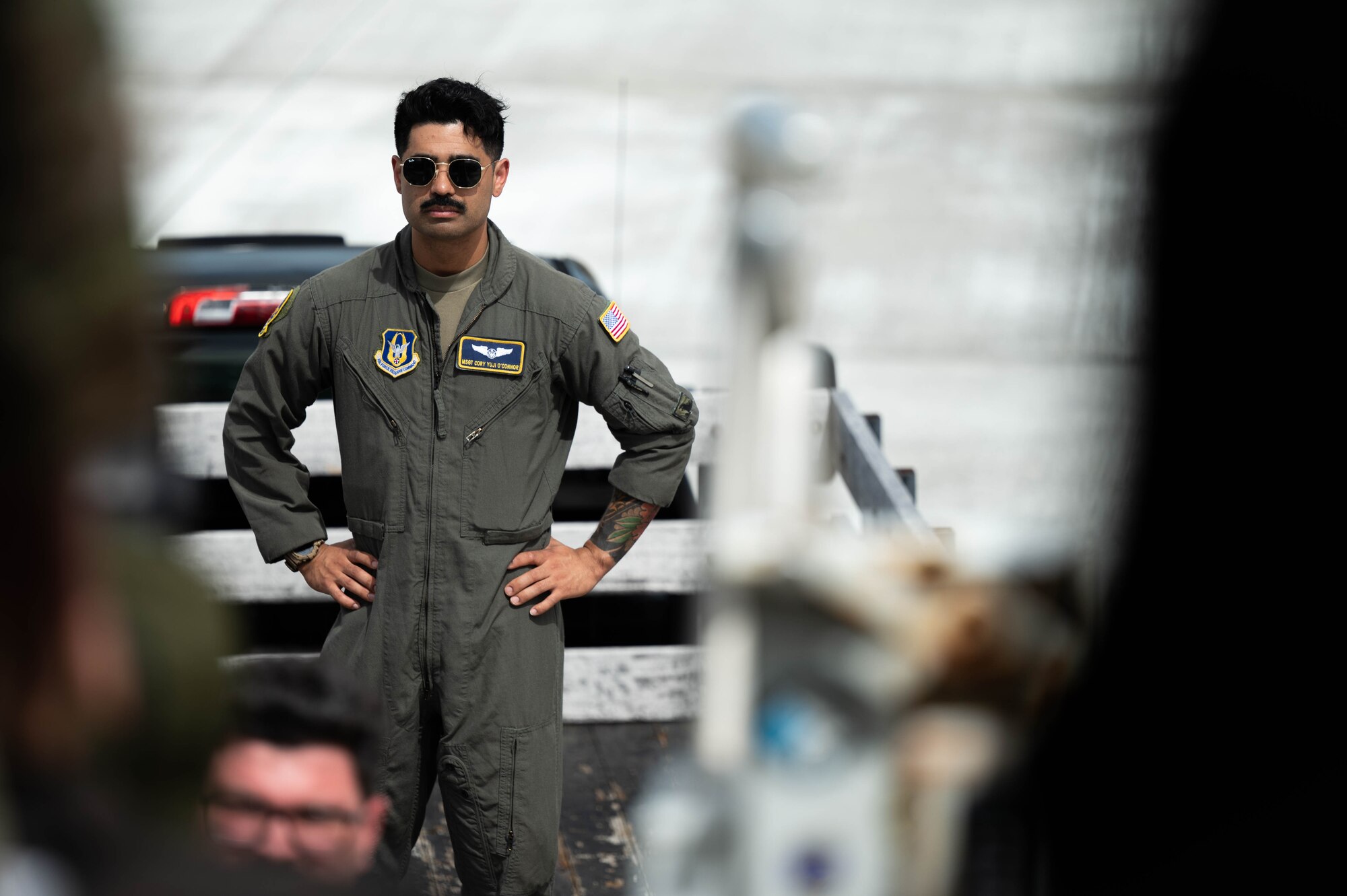 Air force boom operator ready to assist during baggage unload