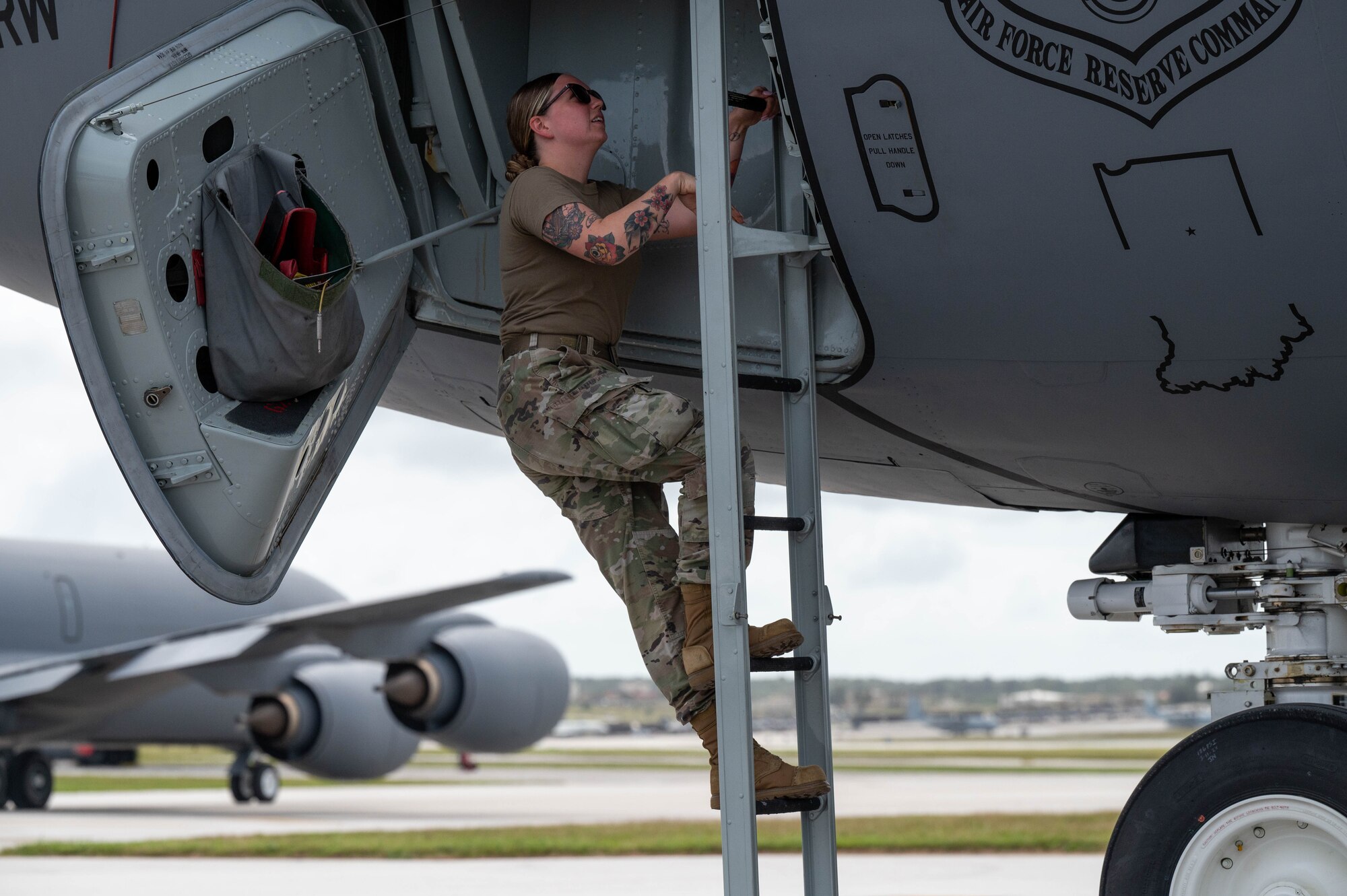 Airman climbs ladder up to flight deck of KC-135