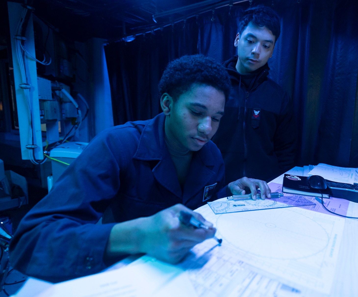 SULU SEA (Feb. 10, 2025) Operations Specialist Seaman Caleb Bell (left) and Operations Specialist 1st Class Jaydione Sales (right) stand watch in the combat information center of the Arleigh Burke-class guided-missile destroyer USS Dewey (DDG 105) during bilateral operations with the Japan Maritime Self-Defense Force Asahi-class destroyer JS Asahi (DD-119), in the Philippine Sea, Feb. 10, 2025. Dewey is forward-deployed and assigned to Destroyer Squadron (DESRON) 15, the Navy’s largest DESRON and the U.S. 7th Fleet’s principal surface force. (U.S. Navy photo by Mass Communication Specialist 1st Class Devin Monroe)