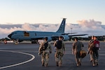 Airmen from the 203rd Air Refueling Squadron and the 169th Air Defense Squadron approach a U.S. Air Force KC-135 Stratotanker assigned to the 203rd Air Refueling Squadron on Joint Base Pearl Harbor-Hickam, Hawaii, Feb 5, 2025, for Sentry Aloha 25-1. Fighter jets, tankers and support units participated in simulated combat scenarios, enhancing interoperability and readiness among U.S. military forces.