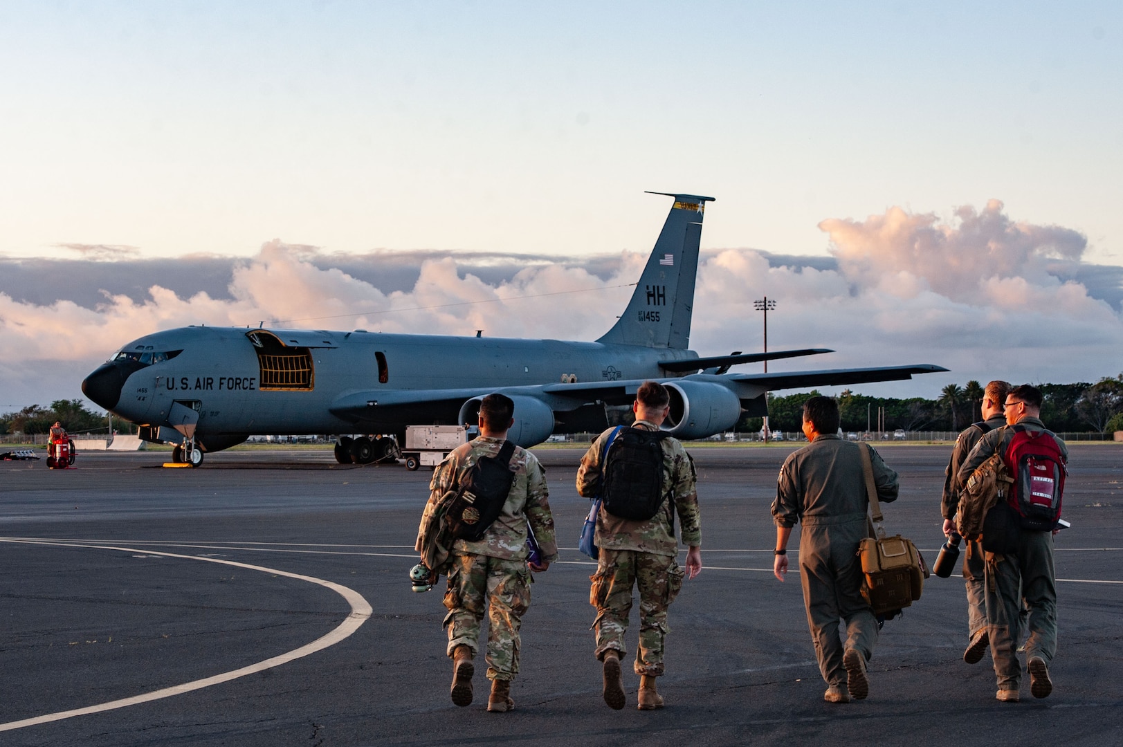 Airmen from the 203rd Air Refueling Squadron and the 169th Air Defense Squadron approach a U.S. Air Force KC-135 Stratotanker assigned to the 203rd Air Refueling Squadron on Joint Base Pearl Harbor-Hickam, Hawaii, Feb 5, 2025, for Sentry Aloha 25-1. Fighter jets, tankers and support units participated in simulated combat scenarios, enhancing interoperability and readiness among U.S. military forces.