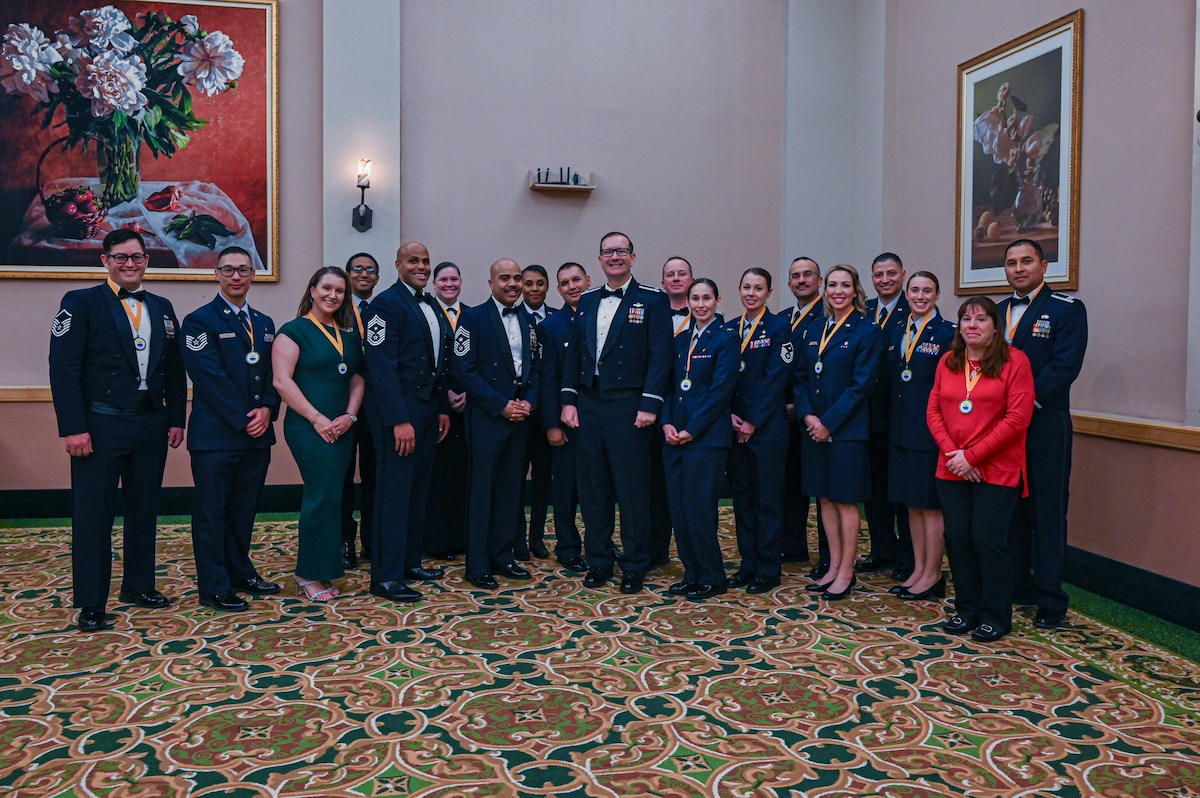 Chief Master Sgt .Johnathan Birk (front left), 433rd Airlift Wing command chief, Chief Master Sgt. Israel Nuñez (front center), Senior Enlisted Advisor to the Chief of Air Force Reserve, and Col. Douglas C. Jeffrey IV (front right), 433rd AW commander, pose for a group photo with the annual award nominees before the 14th Annual Alamo Wing Awards Banquet at the Gateway Club on Joint Base San Antonio-Lackland, Texas Feb. 01, 2025.