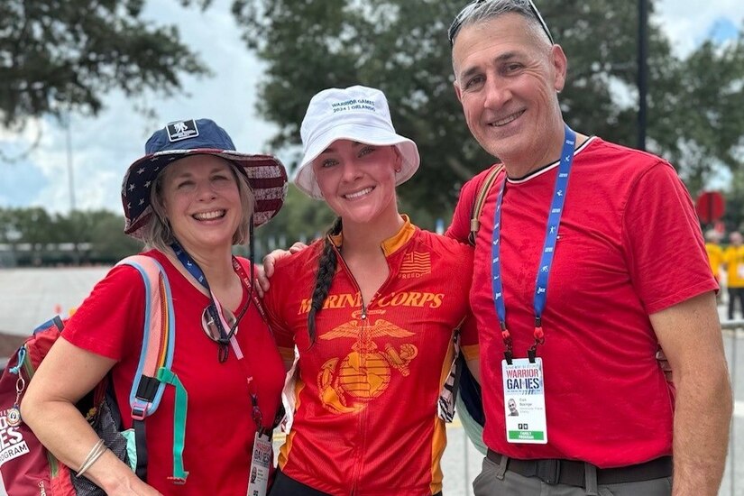 Retired Marine Corps Sgt. Lydia Figary with her parents at the 2024 Warrior Games in Orlando, Florida, last June.