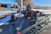 Army Master Sgt. Mike Haley positions himself in his sit-ski gear to shoot in biathlon training for Team U.S. in Park City, Utah.