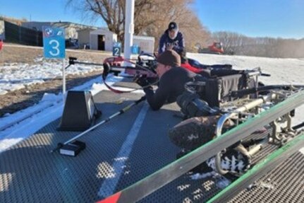Army Master Sgt. Mike Haley positions himself in his sit-ski gear to shoot in biathlon training for Team U.S. in Park City, Utah.