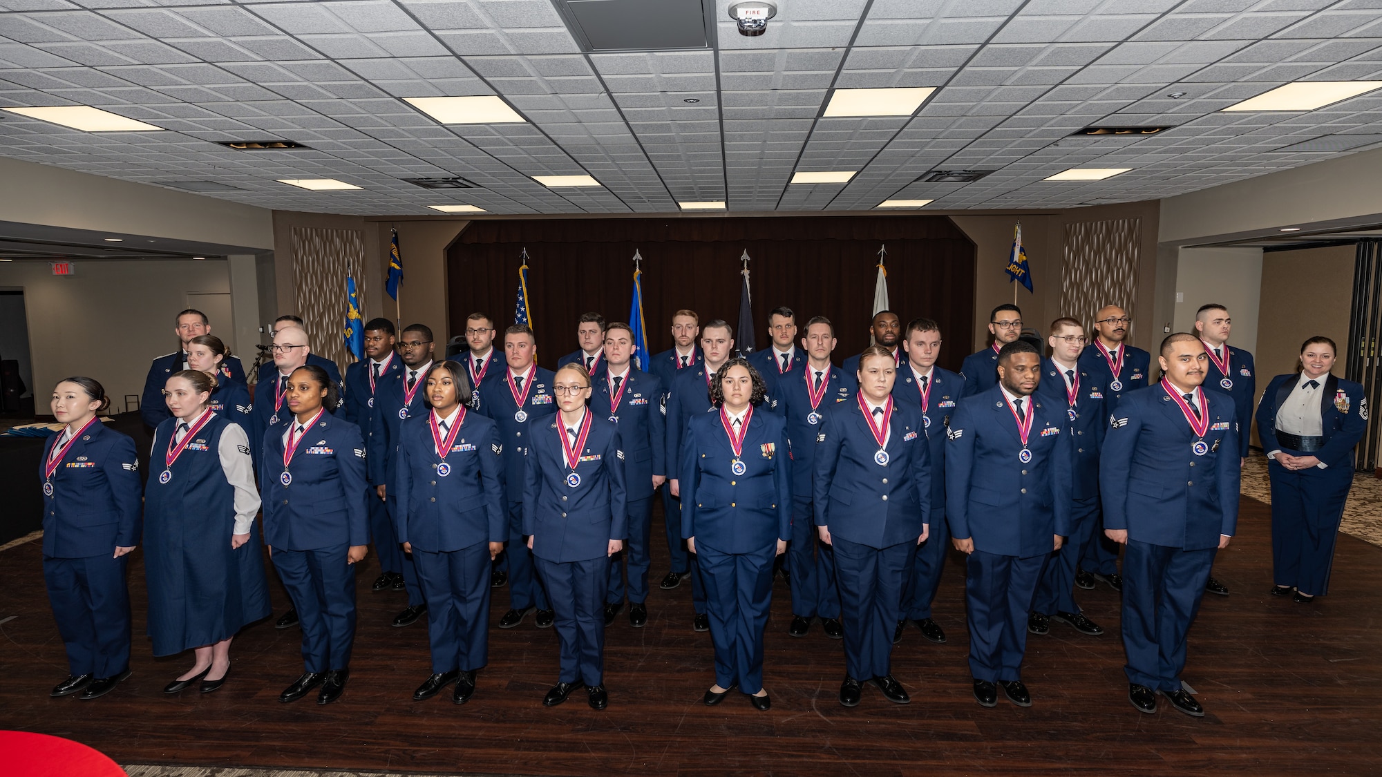 Large group photo of military members in formation wearing formal service dress