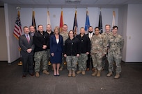 Chief of Naval Operations Adm. Lisa Franchetti takes a group photo with Sailors and Navy civilians at Naval Support Activity (NSA) Crane, in Crane, Indiana, Feb. 10, 2025.