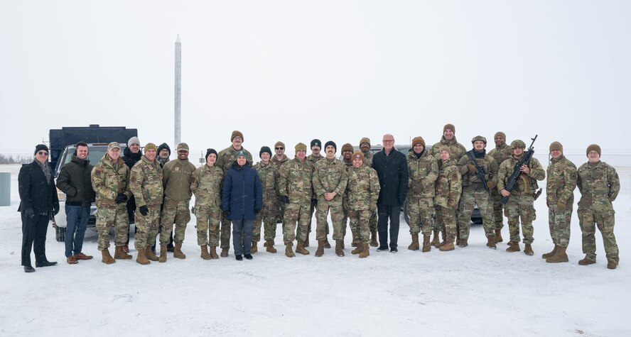 U.S. Air Force Gen. Jim Slife, Air Force vice chief of staff (VCSAF), and U.S. Air Force Lt. Gen. Andrew Gebara, Air Force deputy chief of staff for strategic deterrence and nuclear integration, U.S. Air Force Col. Jimmy Schlabach, 91st Missile Wing commander, and Airmen assigned to the 91MW pose for a group photo during a base visit at a missile launch facility near Minot Air Force Base, North Dakota, Feb. 15, 2025. During the visit, Slife and Gebara met with Airmen assigned to multiple units which contribute to the nation’s nuclear deterrence capabilities. (U.S. Air Force photo by Senior Airman Kyle Wilson)