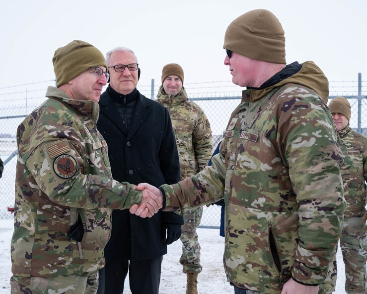 U.S. Air Force Gen. Jim Slife (left), Air Force vice chief of staff (VCSAF), coins U.S. Air Force Staff Sgt. Kai LeBlanc, 91st Missile Security Forces Squadron training instructor, during a base visit at a missile launch facility near Minot Air Force Base, North Dakota, Feb. 15, 2025. Slife presented LeBlanc with the coin as a recognition of exceptional performance. (U.S. Air Force photo by Senior Airman Kyle Wilson)