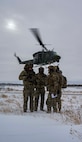 A UH-1N Iroquois assigned to the 54th Helicopter Squadron (54HS) takes off as 91st Missile Security Operations Squadron convoy response force fire observers and Chief Master Sgt. Matthew Tinck, 91st Operations Group senior enlisted leader, provide close air support for training at Minot Air Force Base, North Dakota, Feb. 7, 2025. In addition to providing helicopter security response for the 91st Missile Wing, the 54HS supports emergency war orders by delivering tactical response force teams to assist with convoy operations, launch facility denial and recapture. (U.S. Air Force photo by Senior Airman Alyssa Bankston)