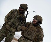 Senior Airman Daquane Williams, 91st Missile Security Operations Squadron convoy response force fire observer (left), and Chief Master Sgt. Matthew Tinck, 91st Operations Group senior enlisted leader (right), provide close air support (CAS) for training at Minot Air Force Base, North Dakota, Feb. 7, 2025. CAS is a military tactic involving the use of aircraft to attack enemy targets near friendly forces. (U.S. Air Force photo by Senior Airman Alyssa Bankston)