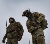 Chief Master Sgt. Matthew Tinck, 91st Operations Group senior enlisted leader (left), and Senior Airman Daquane Williams, 91st Missile Security Operations Squadron convoy response force fire observer (right), provide close air support (CAS) for training at Minot Air Force Base, North Dakota, Feb. 7, 2025. CAS is a military tactic in which enemy targets close to friendly forces are attacked by aircraft. (U.S. Air Force photo by Senior Airman Alyssa Bankston)