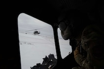 U.S. Air Force Staff Sgt. Garrett Hightower, 54th Helicopter Squadron flight engineer, looks out of a UH-1N Iroquois during flight at Minot Air Force Base, North Dakota, Feb. 7, 2025. Since the 1950s, the UH-1 “Huey” has been used by the Department of Defense with widespread use during the Vietnam War. (U.S. Air Force photo by Senior Airman Alyssa Bankston)
