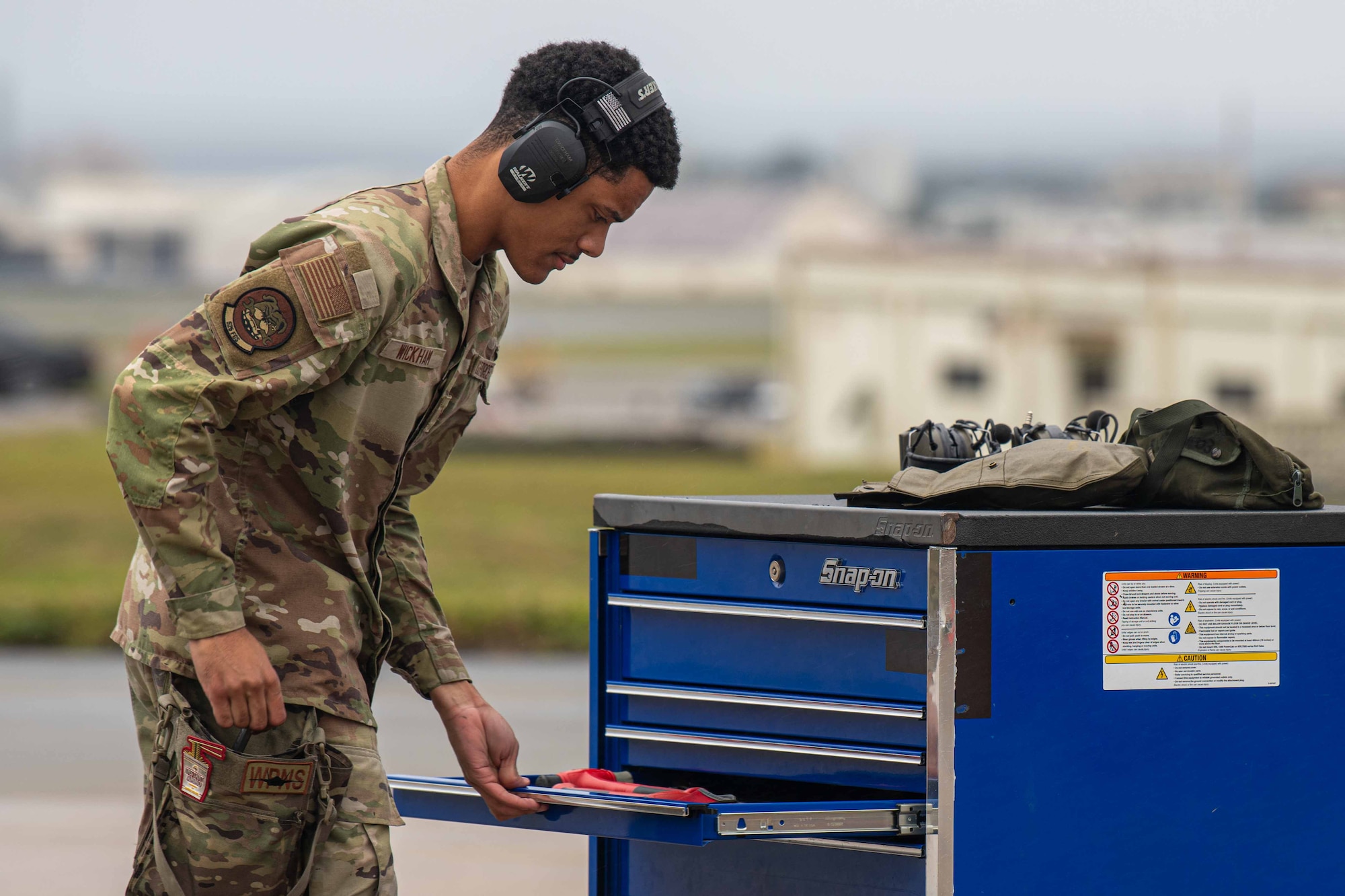 U.S. Air Force Senior Airman Tyler Wickham, 525th Fighter Generation Squadron weapons load crew member, retrieves a tool during a weapons load competition at Kadena Air Base, Japan, Feb. 7, 2025.