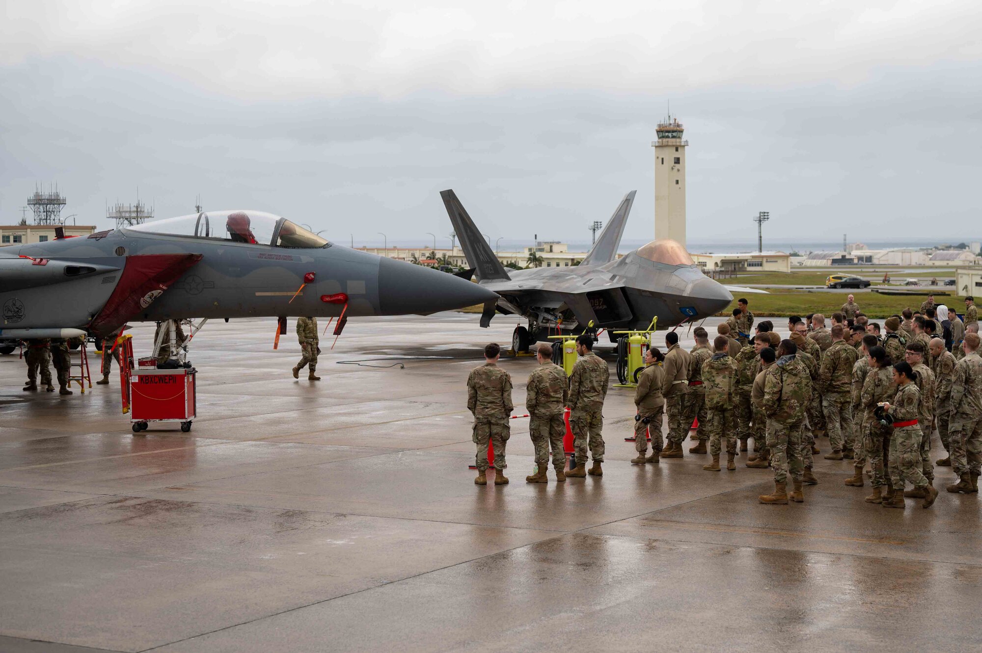 U.S. Air Force Airmen gather to watch the 18th Wing Load Crew of the Quarter competition at Kadena Air Base, Japan, Feb. 7, 2025.