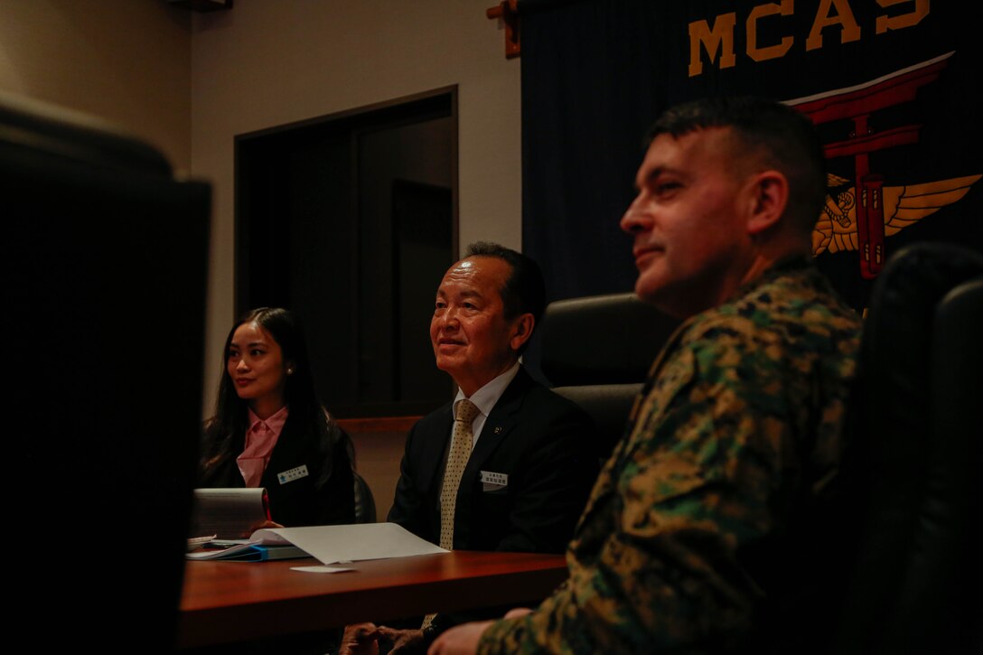 U.S. Marine Corps Col. Richard Rusnok, right, the commanding officer of Marine Corps Air Station Iwakuni, and a native of Pennsylvania, and Mr. Taketoyo Toguchi, the mayor of Nago, left, listen to a command brief about the history and capabilities of the installation at MCAS Iwakuni, Japan, Feb. 7, 2025. Mr. Taketoyo Toguchi and his staff visited MCAS Iwakuni to discuss its relationship with the local community. (U.S. Marine Corps photo by Sgt. Peter Rawlins)