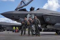 From left: FLTLT Mitchell, SQNLDR James and FLTLT Jason, Royal Australian Air Force pilots,  pose for photo in front of F-35A Lightning II after successfully landing their jets on the flight-line for exercise Cope North 25 at Andersen Air Force Base, Guam, Feb. 13, 2025.