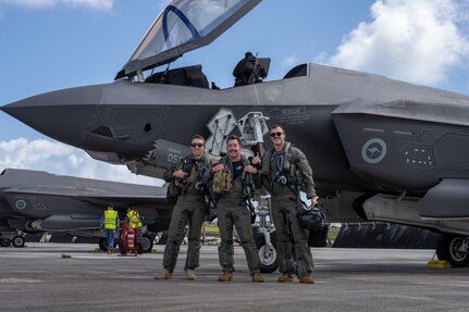 From left: FLTLT Mitchell, SQNLDR James and FLTLT Jason, Royal Australian Air Force pilots,  pose for photo in front of F-35A Lightning II after successfully landing their jets on the flight-line for exercise Cope North 25 at Andersen Air Force Base, Guam, Feb. 13, 2025.