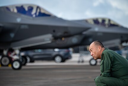 Japan Self Defense Force Maj. Gen. Yukinori Yanagi, director of Defense Plans and Operations Directorate, admires F-35A Lightning II aircraft on the flight line during exercise Cope North 25 at Andersen Air Force Base, Guam, Feb. 13, 2025.